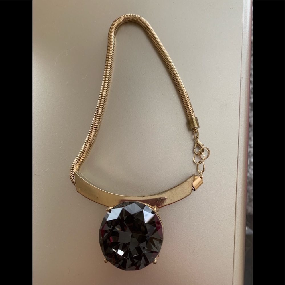 Gold necklace with big gray stone